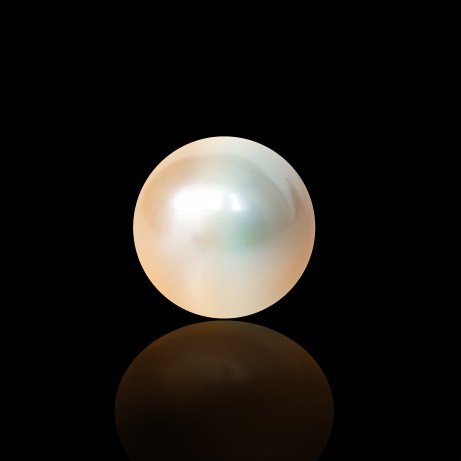 A single lustrous pearl resting on a reflective surface against a black background.